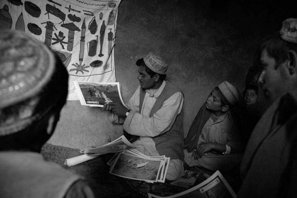 In all villages, local volunteers are trained in Mine Risk Education (MRE). This to be able to do retraining and inform all villagers of the hazardous environment whenever it is needed. Most boys in the class room lost one leg in a mine field : Demining in Kabul : Charlotte Oestervang Photography